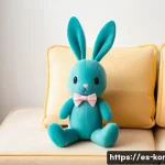 콩지래빗 테마 굿즈 제작 과정 - A cozy, high-quality plush Kongji Rabbit toy sitting on a pastel-colored sofa in a bright, modern li...