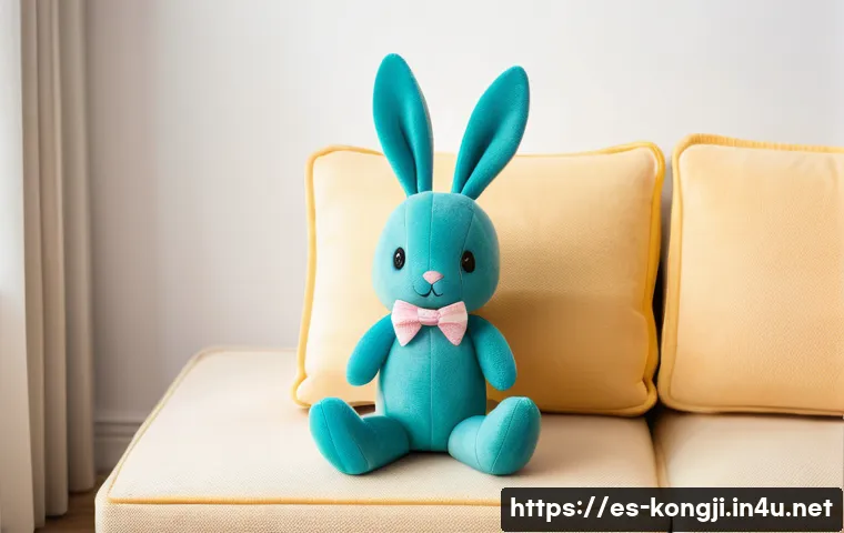 콩지래빗 테마 굿즈 제작 과정 - A cozy, high-quality plush Kongji Rabbit toy sitting on a pastel-colored sofa in a bright, modern li...